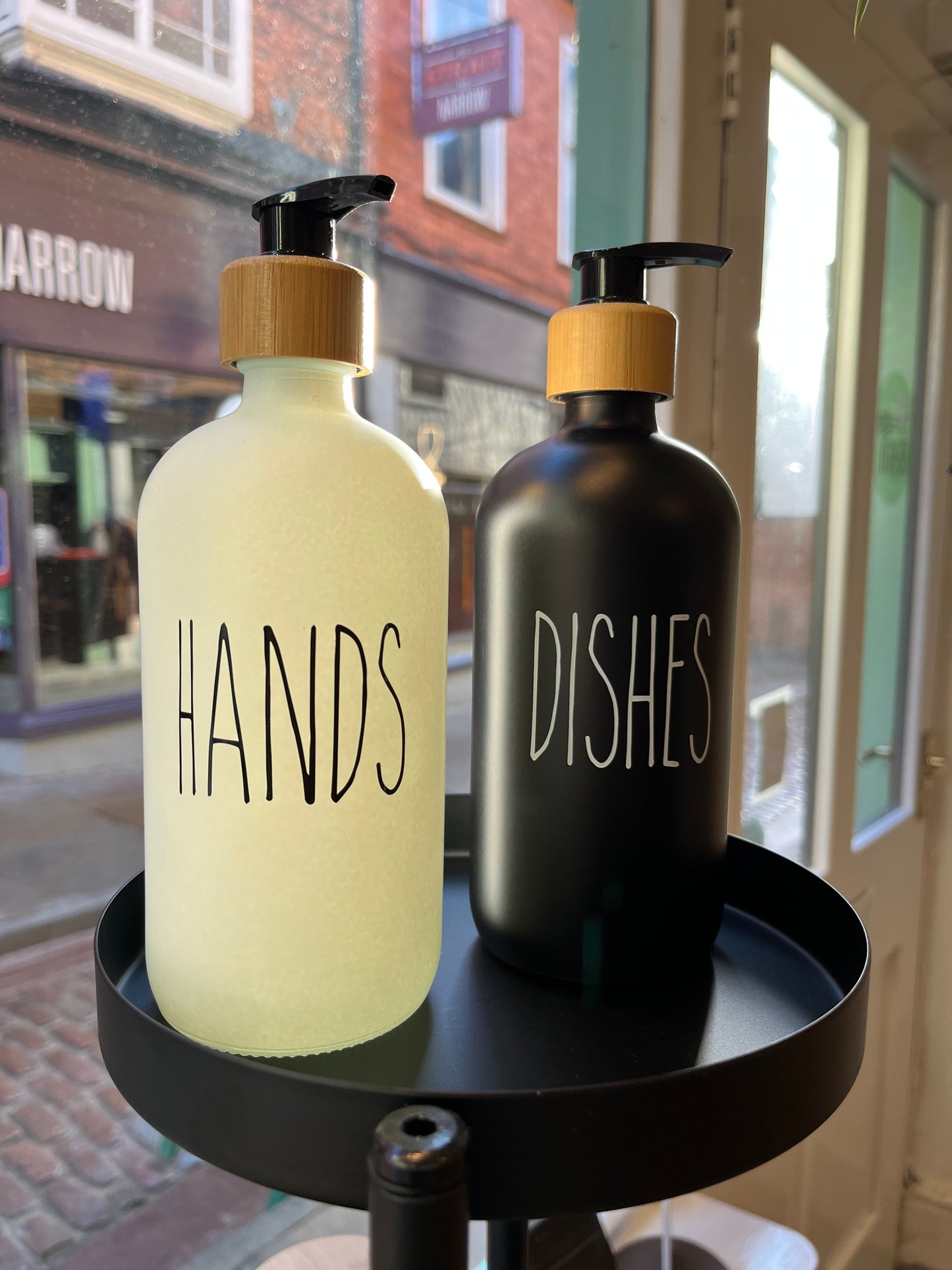 Minimal design glass pump bottles perfect for dispensing hand soap & washing up liquid in opaque black & white glass with a bamboo screw top and black pump. Choose from a black ‘dishes’ or a white ‘hands’ design. Holds 500ml.